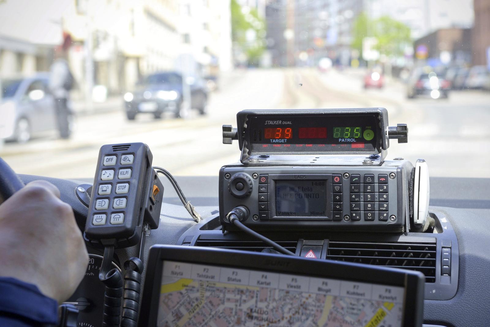 Police speed enforcement radar unit and controller mounted on the dashboard of a patrol vehicle