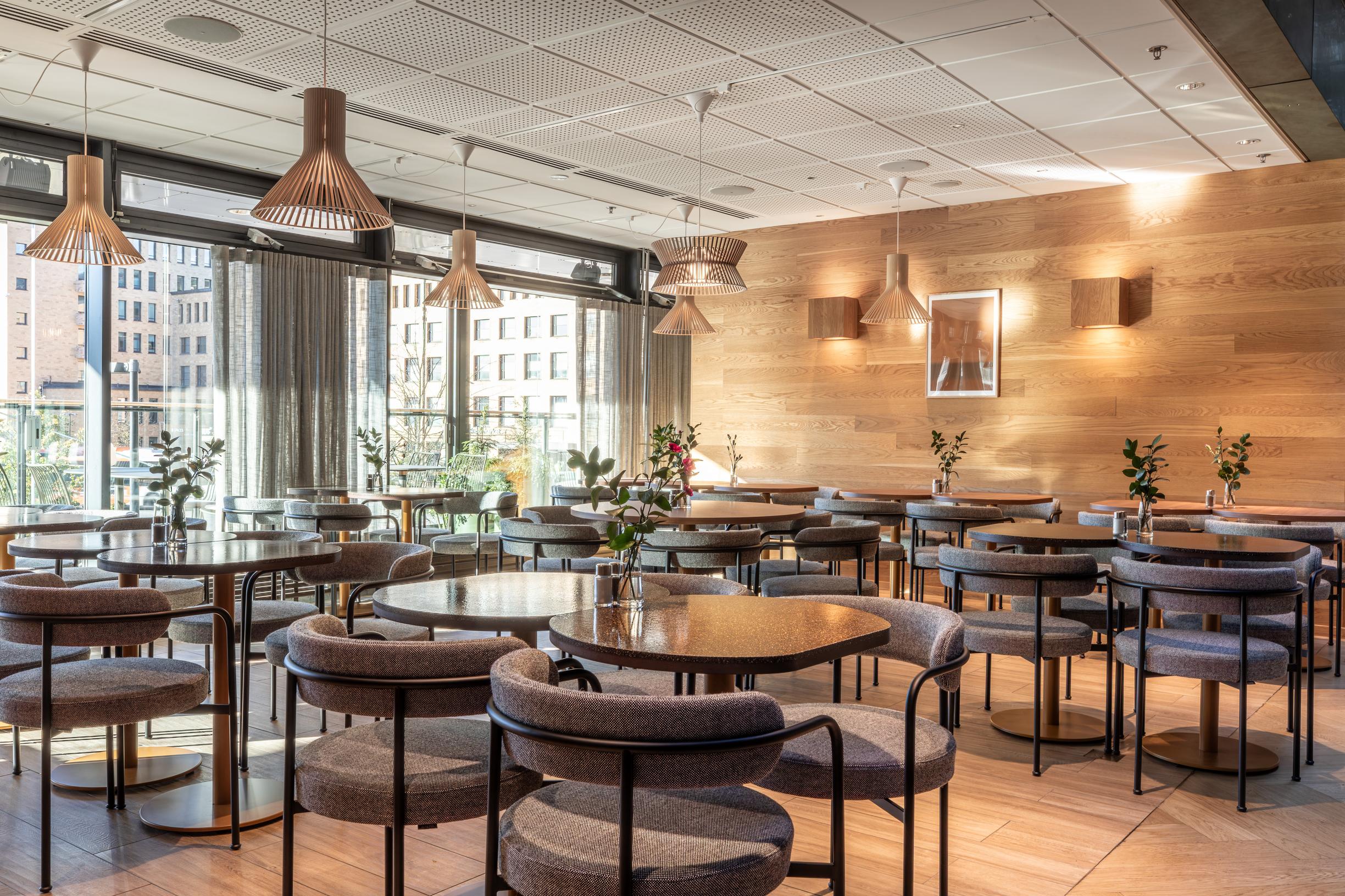 Scandic Helsinki Station -hotellin viihtyisä sali toisessa kerroksessa, jossa tarjoillaan aamupala.